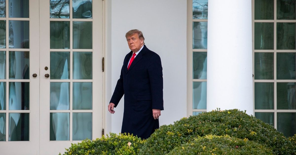 President Donald Trump walks to the Oval Office while arriving back at the White House on Tuesday in Washington, D.C.