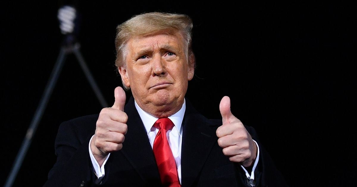 President Donald Trump gives two thumbs up during a rally in support of incumbent Republican Sens. Kelly Loeffler and David Perdue ahead of the Senate runoffs in Dalton, Georgia, on Jan. 4, 2021.