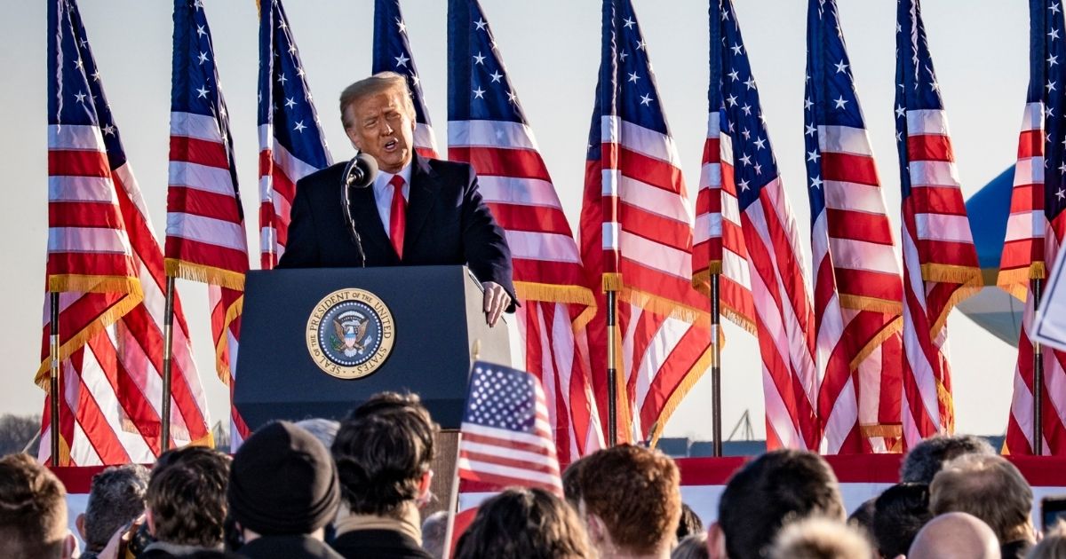 Former President Donald Trump speaks to supporters at Joint Base Andrews before boarding Air Force One for his last time as president on Wednesday.