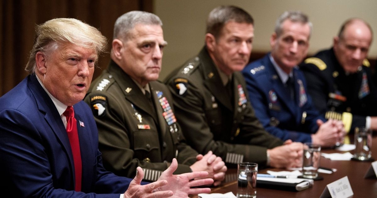 Chairman of the Joint Chiefs of Staff Army General Mark A. Milley, second from left, and others listen as President Donald Trump speaks during a meeting with senior military leaders in the Cabinet Room of the White House on Oct. 7, 2019, in Washington, D.C.
