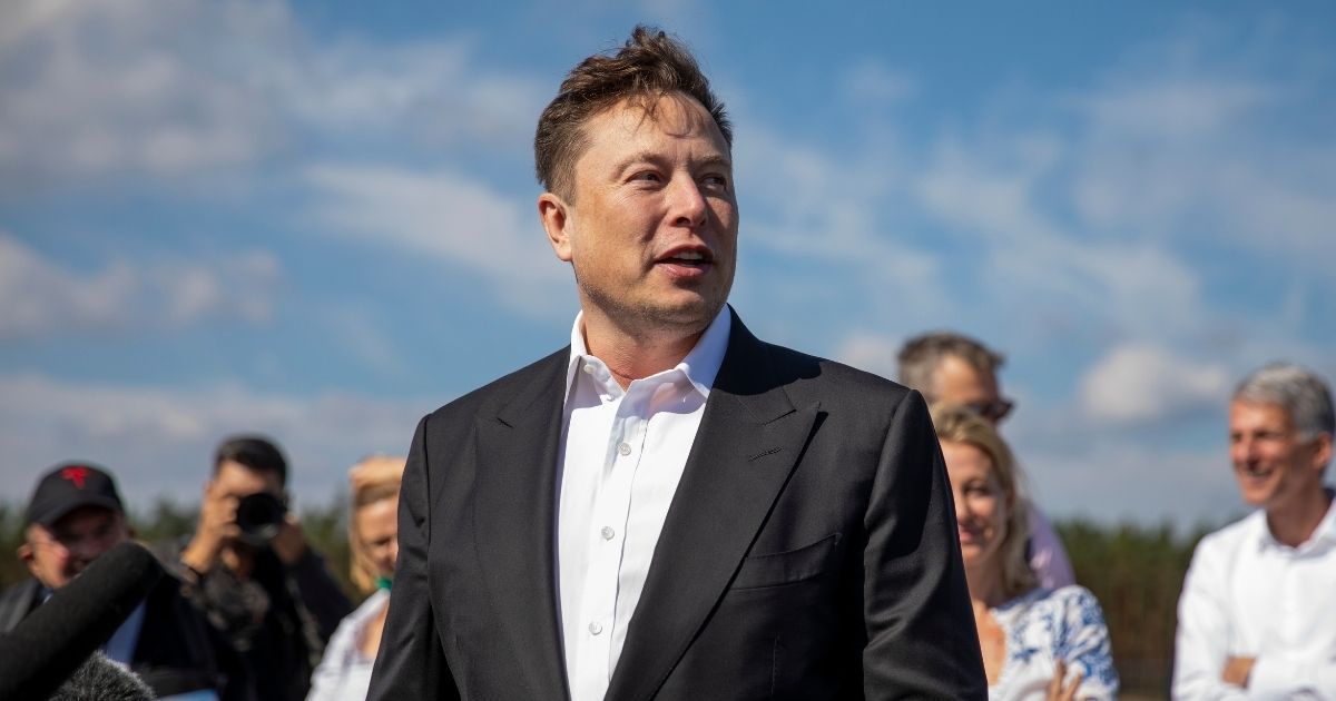 Tesla CEO Elon Musk talks to the media as he arrives to look at the construction site of the Tesla Gigafactory near Berlin on Sept. 3, 2020.