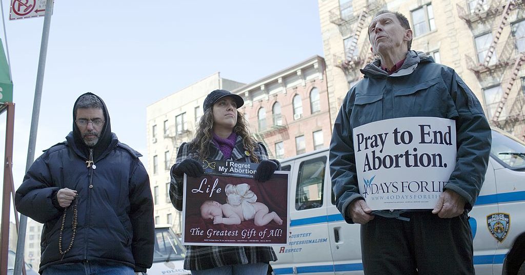 Pro-life protesters line the sidewalk outside the Dr. Emily Women's Health Center March 12, 2011, in Bronx, New York.