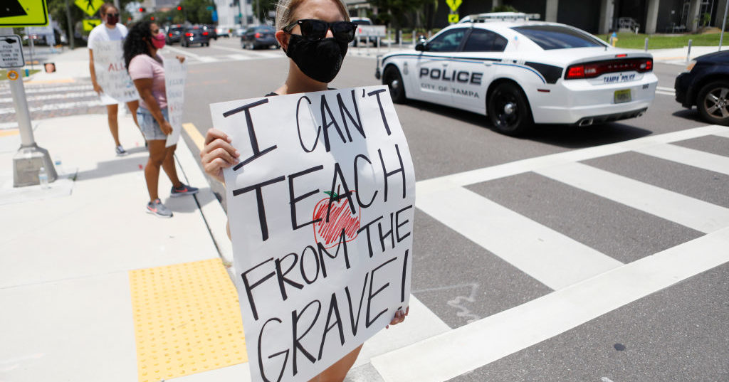 Middle school teacher Brittany Myers stands in protest in front of the Hillsborough County Schools District Office on July 16, 2020 in Tampa, Florida.