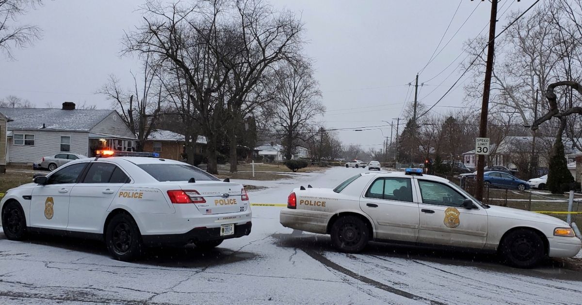 The Indianapolis Metropolitan Police Department works the scene on Sunday in Indianapolis where five people, including a pregnant woman, were shot to death early Sunday inside an Indianapolis home.