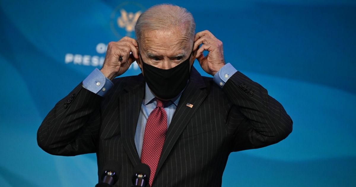 President-elect Joe Biden puts his face mask on as he leaves after announcing nominees for his economic and jobs team at The Queen Theater in Wilmington, Delaware, on Jan. 8, 2021.