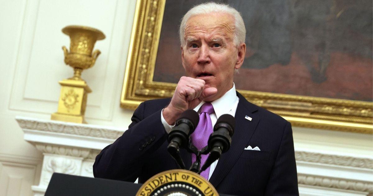 President Joe Biden clears his throat as he speaks during an event in the State Dining Room of the White House in Washington on Thursday.