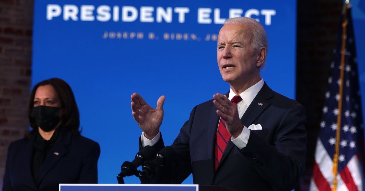President-elect Joe Biden speaks as Vice President-elect Kamala Harris looks on during day two of laying out his plan on combating the coronavirus at The Queen theater in Wilmington, Delaware, on Friday.