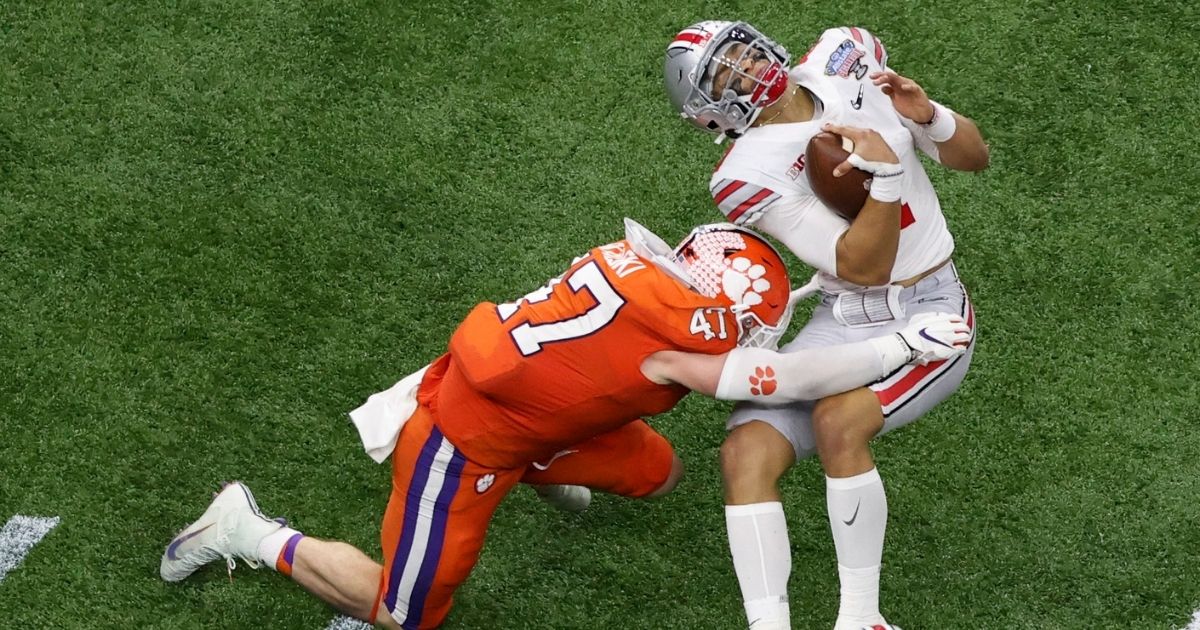 Ohio State quarterback Justin Fields gets hit by Clemson linebacker James Skalski during the first half of the Sugar Bowl NCAA college football game Jan. 1, 2021, in New Orleans. Skalski was ejected from the game for targeting.