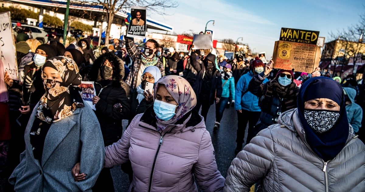 Protesters rally against police brutality Sunday in Minneapolis at the gas station where Dolal Idd was shot by Minneapolis police several days earlier.