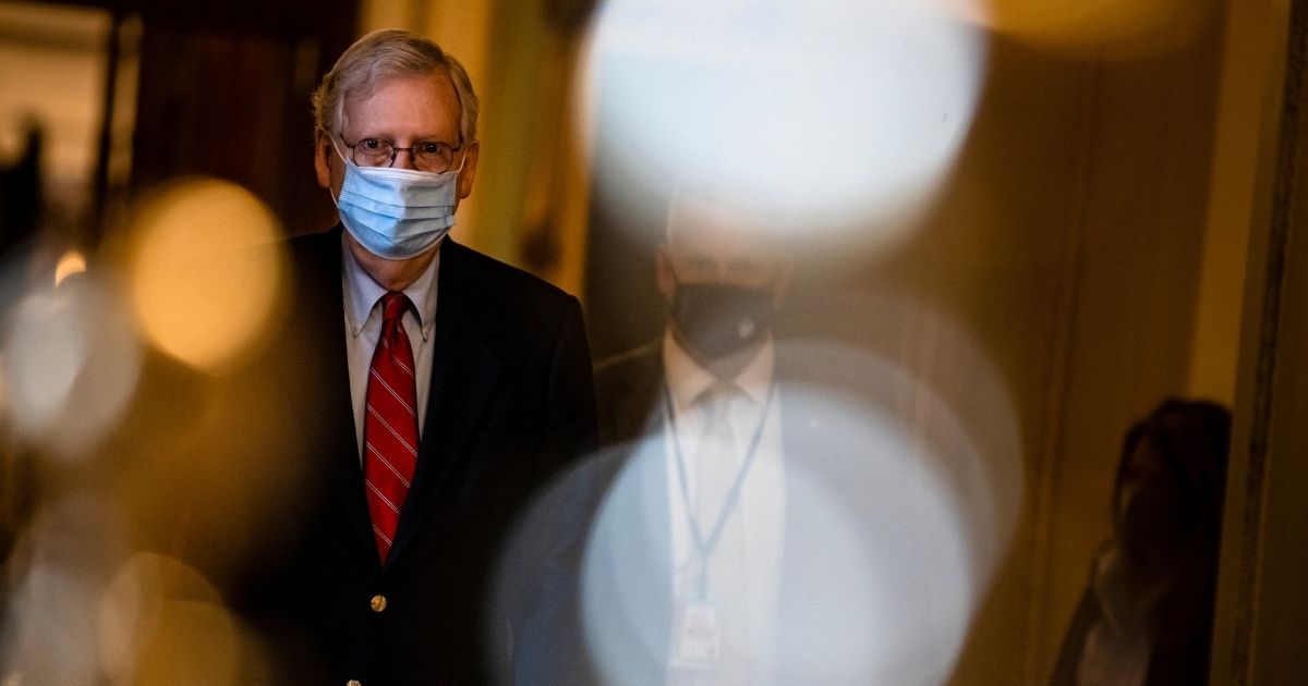 Senate Majority Leader Mitch McConnell heads to his office from the floor of the Senate on Dec. 20, 2020, in Washington, D.C.