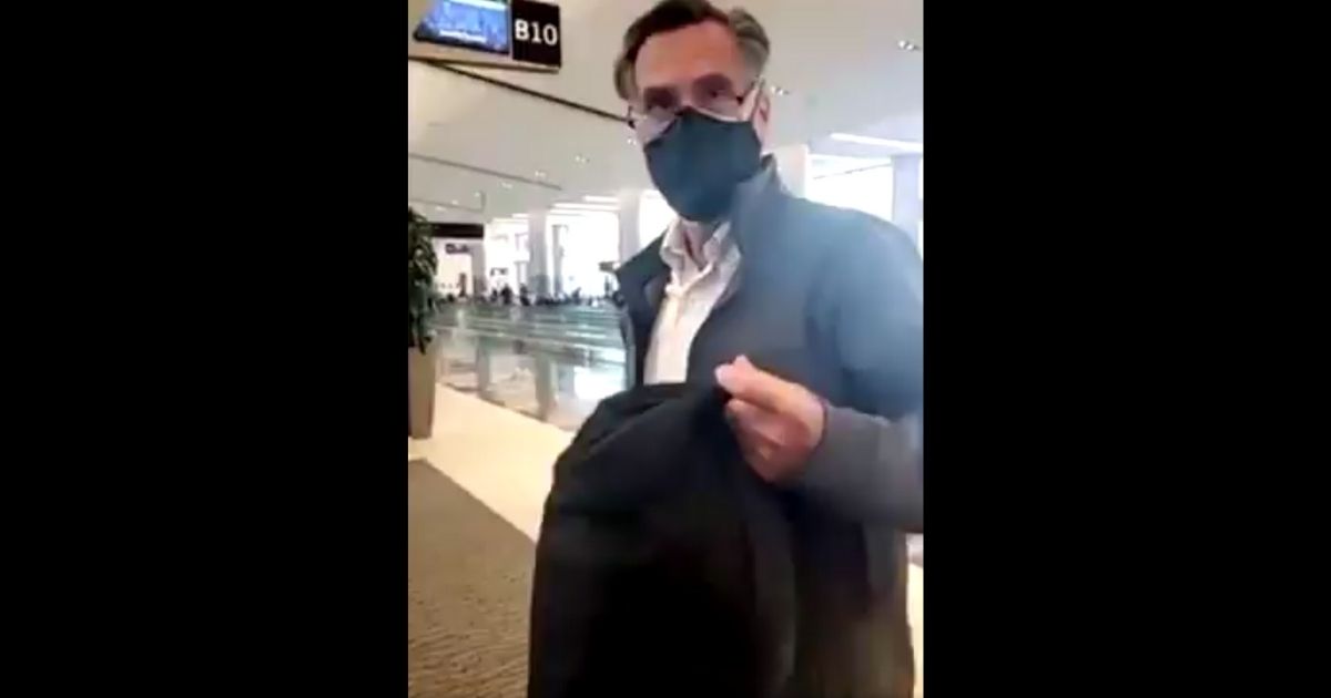 Utah Sen. Mitt Romney is confronted at the Salt Lake City International Airport by President Donald Trump's supporters on Tuesday.