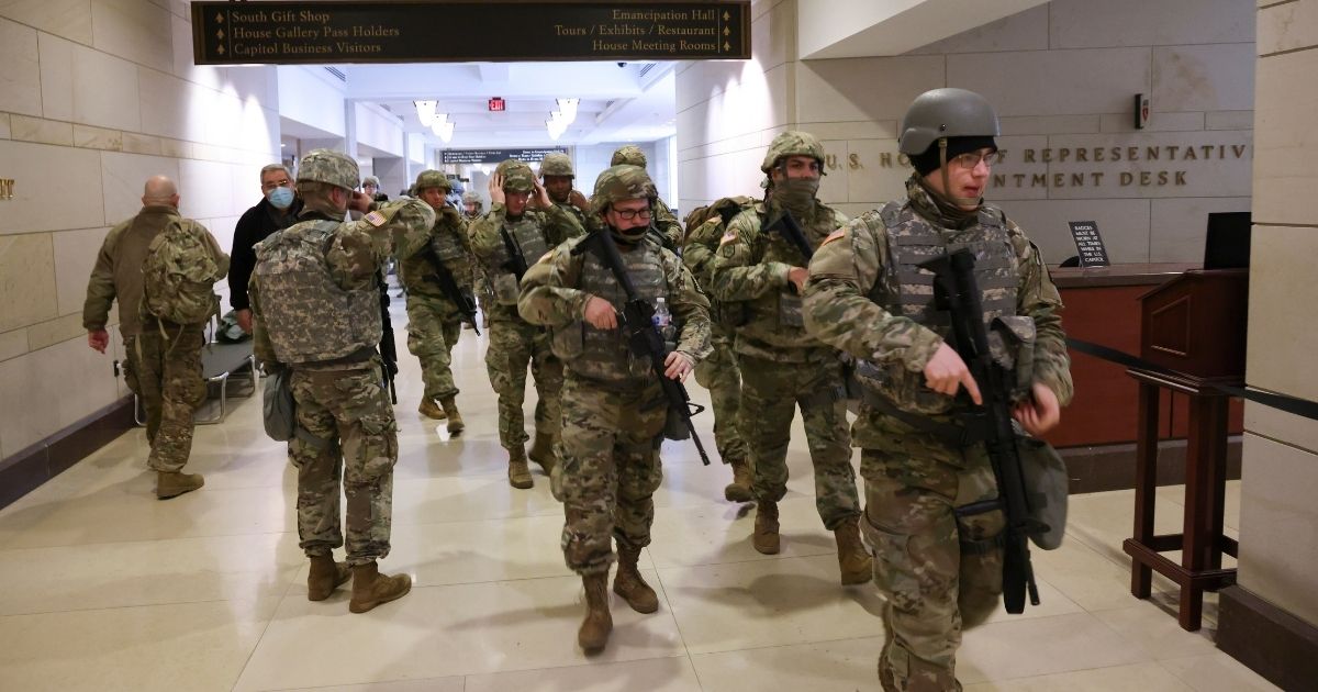 National Guard troops leave the U.S. Capitol Visitor Center during a lockdown due to a threat during the dress rehearsal for the inauguration of President-elect Joe Biden on Monday in Washington, D.C.