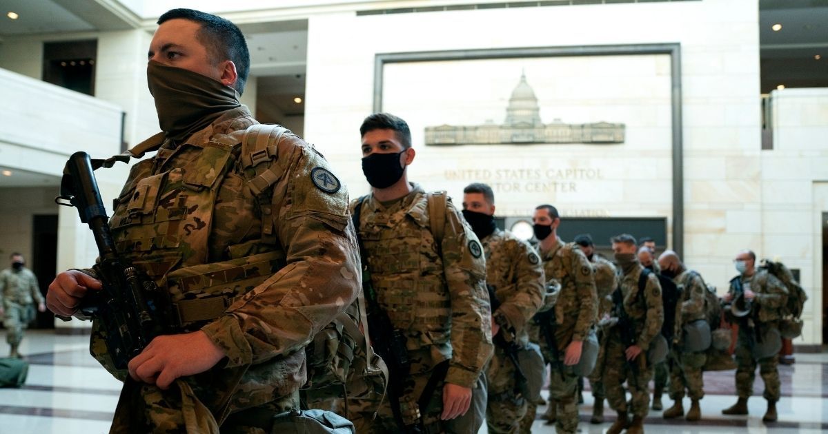 Members of the National Guard walk through the Visitor Center of the U.S. Capitol in Washington on Wednesday.