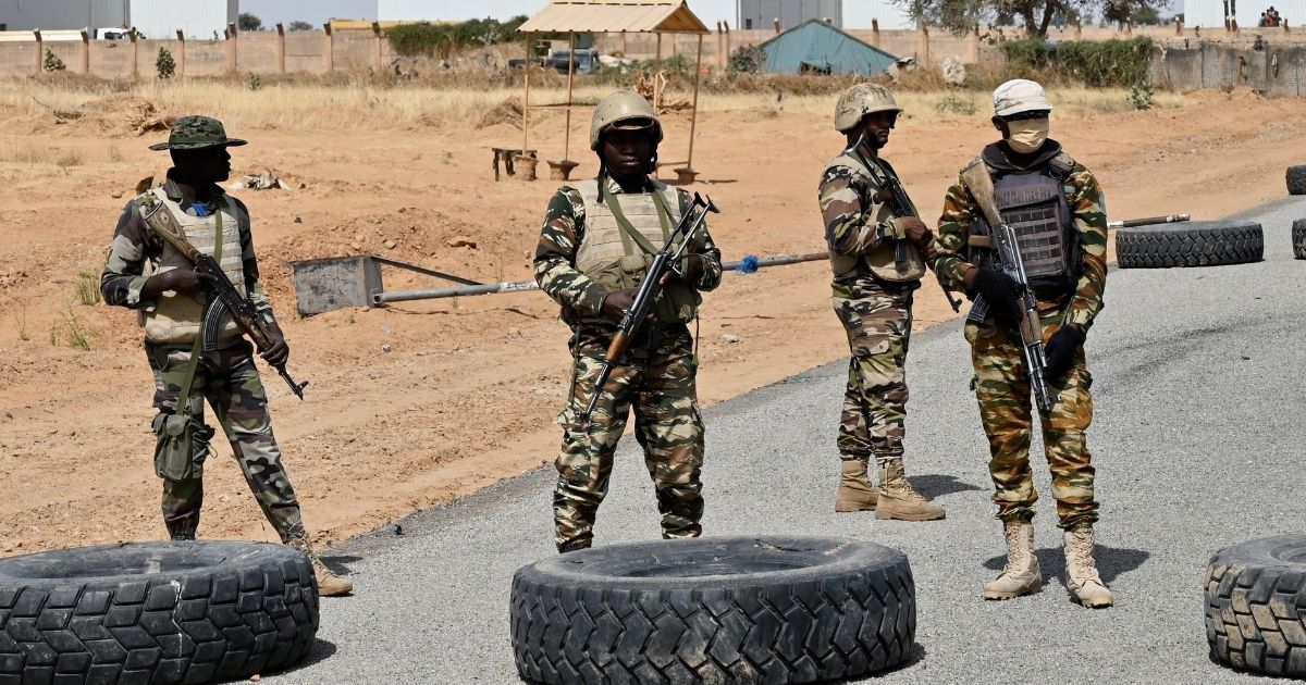 Nigerien soldiers stand guard outside the Diffa airport in southeast Niger, near the Nigerian border, on Dec. 23, 2020.