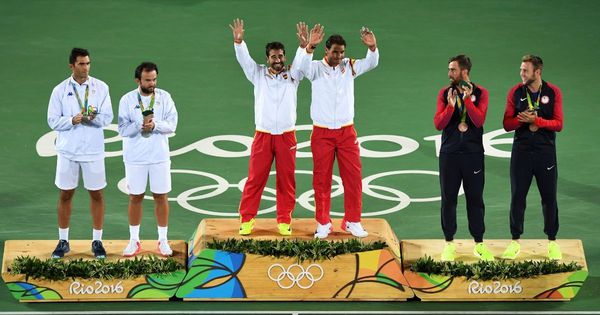 Olympic athletes celebrate on the podium of the men's doubles final tennis match at the Olympic Tennis Centre of the Rio 2016 Olympic Games in Rio de Janeiro on Aug. 12, 2016.