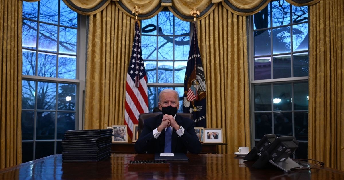 President Joe Biden sits in the Oval Office at the White House in Washington after being sworn in at the U.S. Capitol on Jan. 20, 2021.