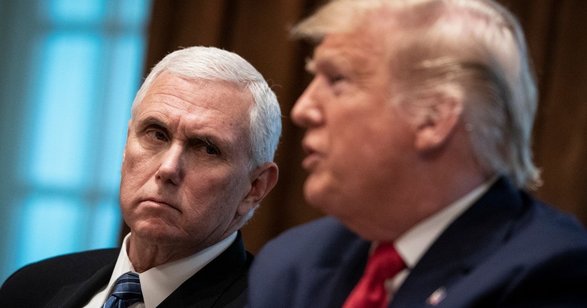 Vice President Mike Pence listens to President Donald Trump during a meeting in the Cabinet Room of the White House on March 2.