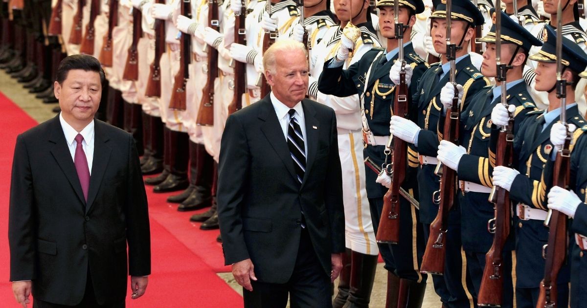 Then-Vice President Xi Jinping of China accompanies then-U.S. Vice President Joe Biden to view an honor guard during a welcoming ceremony inside the Great Hall of the People in Beijing on Aug. 18, 2011.