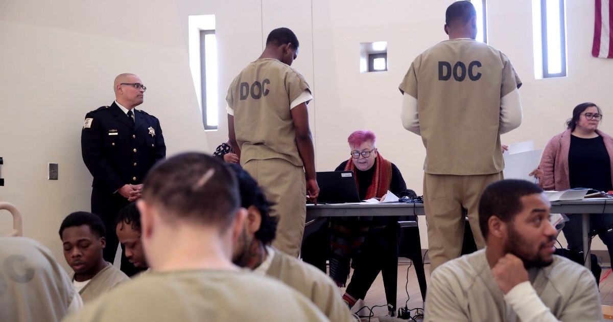 Inmates at the Cook County Jail in Chicago check in with election judges before voting in the Illinois primary election on March 7.