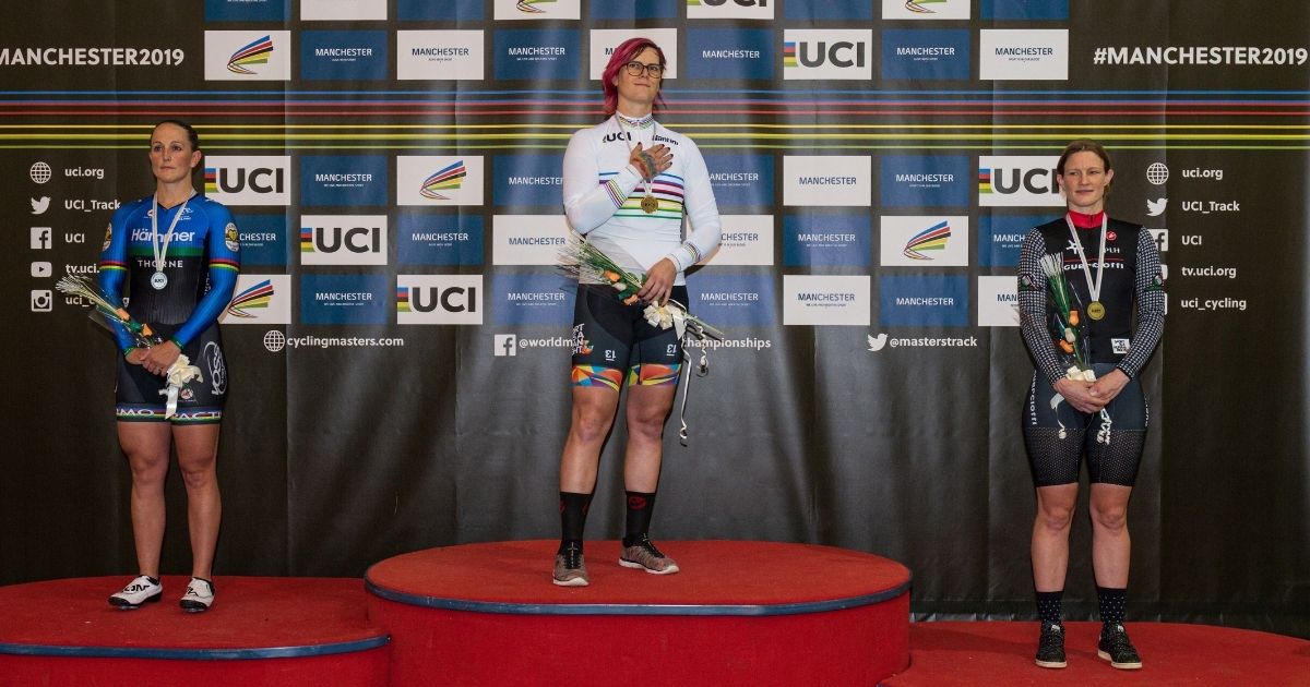 Transgender Canadian cyclist Rachel McKinnon, center, celebrates winning a gold medal on the podium with bronze medalist Kirsten Herup Sovang of Denmark, right, and silver medalist Dawn Orwick of the United States, for the F35-39 Sprint discipline of the UCI Masters Track Cycling World Championships in Manchester on Oct.19, 2019.