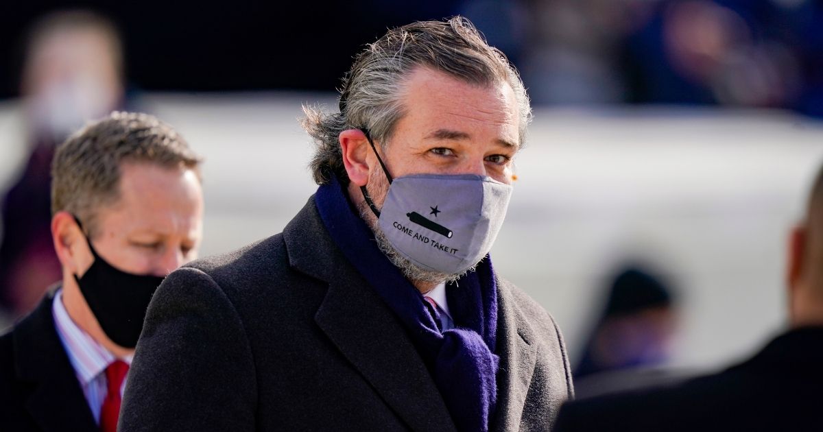 Republican Sen. Ted Cruz of Texas, wearing a face mask that reads, "Come and Take It," arrives at the inauguration of President Joe Biden on the West Front of the U.S. Capitol on Wednesday in Washington, D.C.