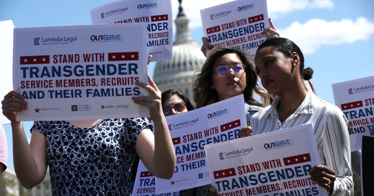 Activists rally in favor of allowing transgenders in the military April 10, 2019, at the Reflecting Pool of the U.S. Capitol in Washington.