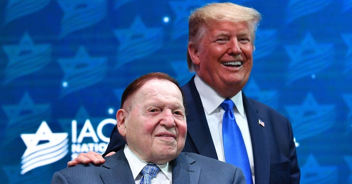 President Donald Trump stands with Sheldon Adelson before his address to the Israeli American Council National Summit 2019 at the Diplomat Beach Resort in Hollywood, Florida, on Dec. 7, 2019.
