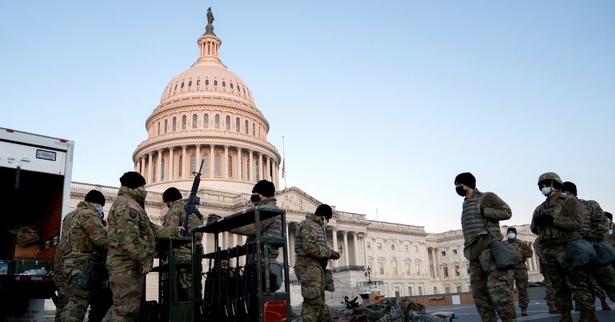 Weapons are distributed to members of the National Guard outside the U.S. Capitol on Wednesday in Washington, D.C.