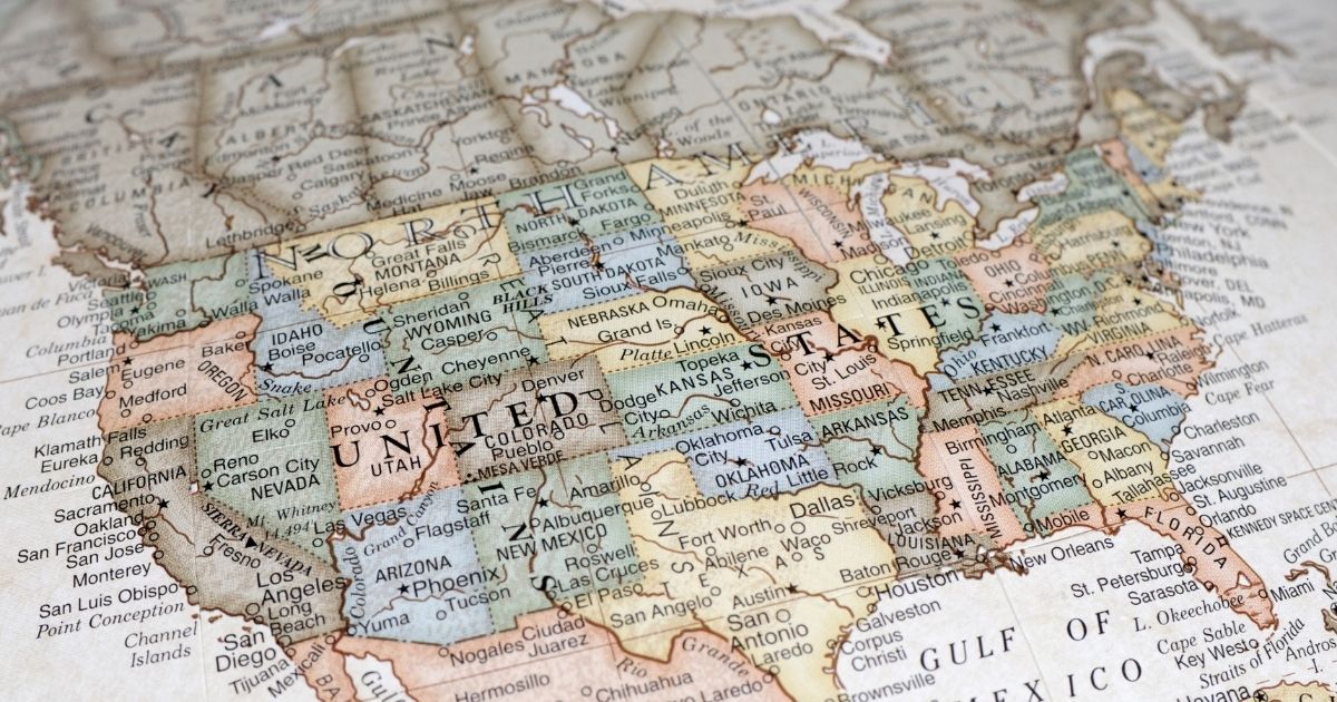 The stock photo above shows a close-up photograph of a map of the United States of America.