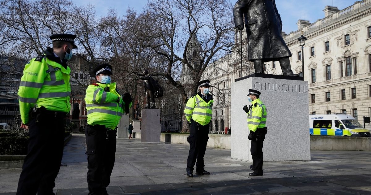 Police officers patrol near the Winston Churchill statue opposite parliament in London on Jan. 23, 2021, during England's third national lockdown since the coronavirus outbreak began.