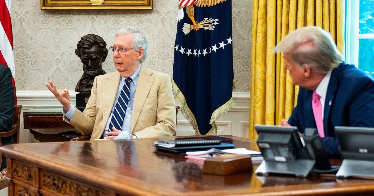 Senate Majority Leader Mitch McConnell and President Donald Trump are pictured in a file photo from the Oval Office in July.