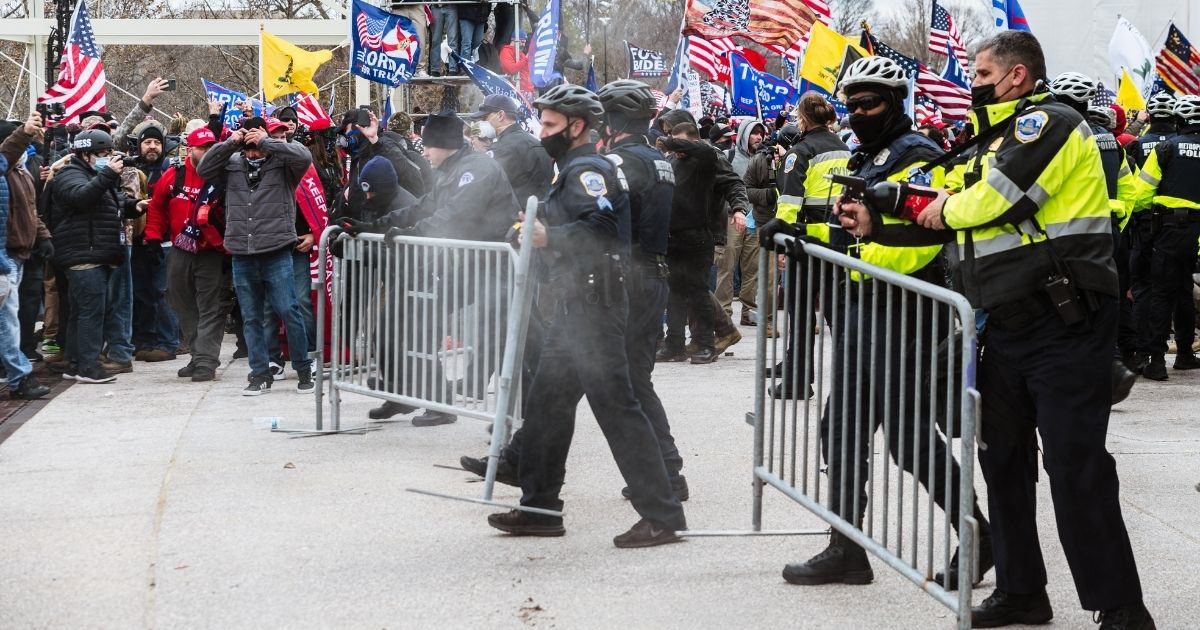 Supporters of President Donald Trump square off Jan. 6 against Capitol Police officers during the Jan. 6 confrontation that led to a pro-Trump mob storming through the Capitol. A Chicago man who was falsely identified on social media as being part of that mob is still dealing with the fallout.