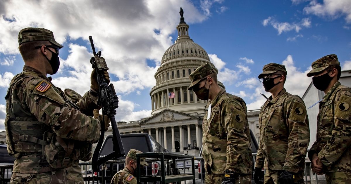 Virginia National Guard soldiers are issued rifles and live ammunition outside the Capitol on Sunday.