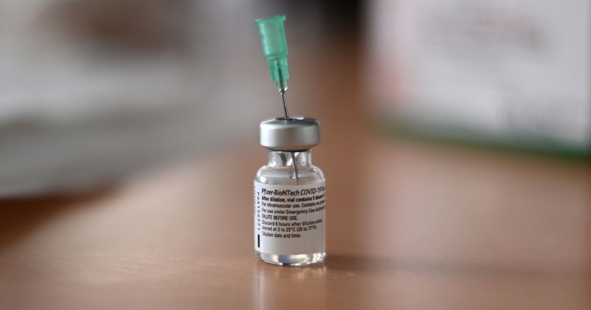 An injection needle sits in a vial with the Pfizer-BioNTech Covid-19 vaccine at a senior living facility in Froendenberg, Germany, on Friday.