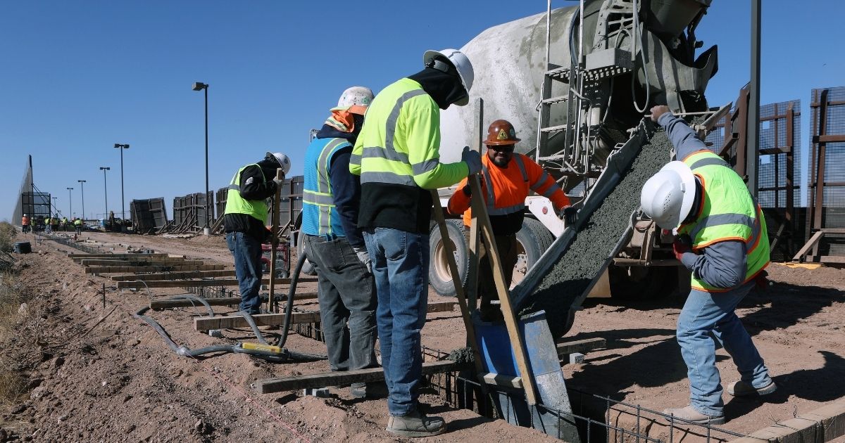Construction workers pour cement as they build part of a border wall between Columbus, New Mexico, and Puerto Palomas de Villa, Mexico, on Nov. 30.