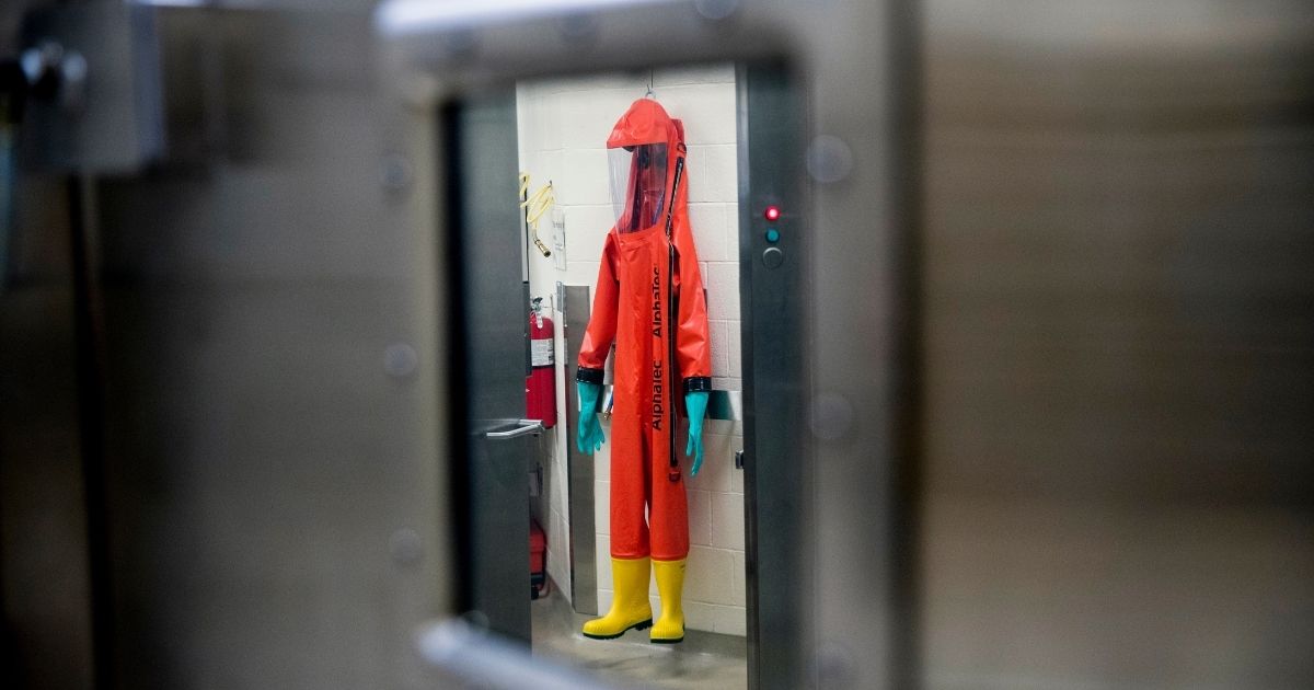 In this March 19, 2020, file photo, a biosafety protective suit for handling viral diseases is hung up in a biosafety level 4 training facility at U.S. Army Medical Research and Development Command at Fort Detrick.