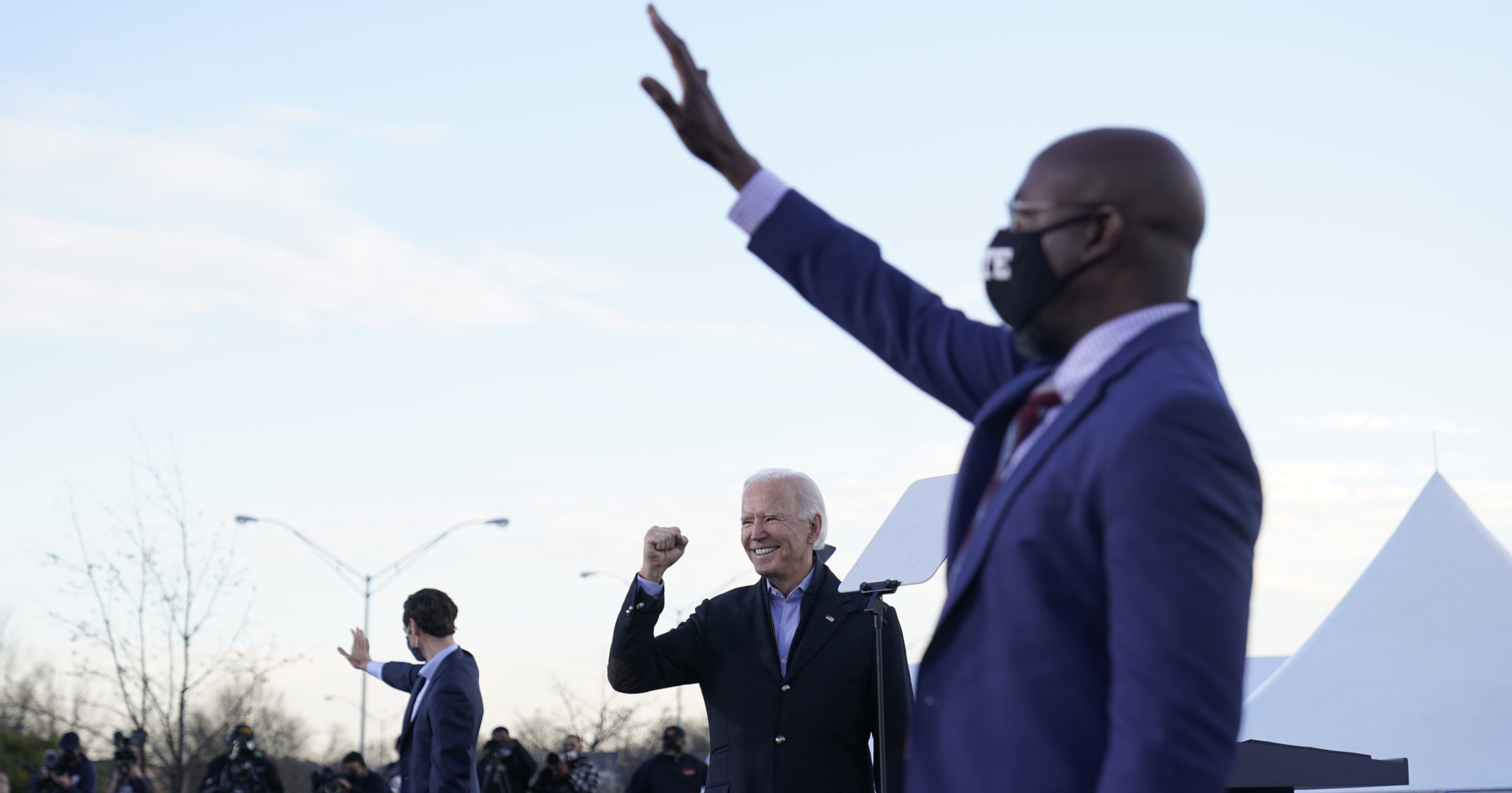 Presumptive President-elect Joe Biden campaigns in Atlanta on Monday for Senate candidates Raphael Warnock, right, and Jon Ossoff, left.