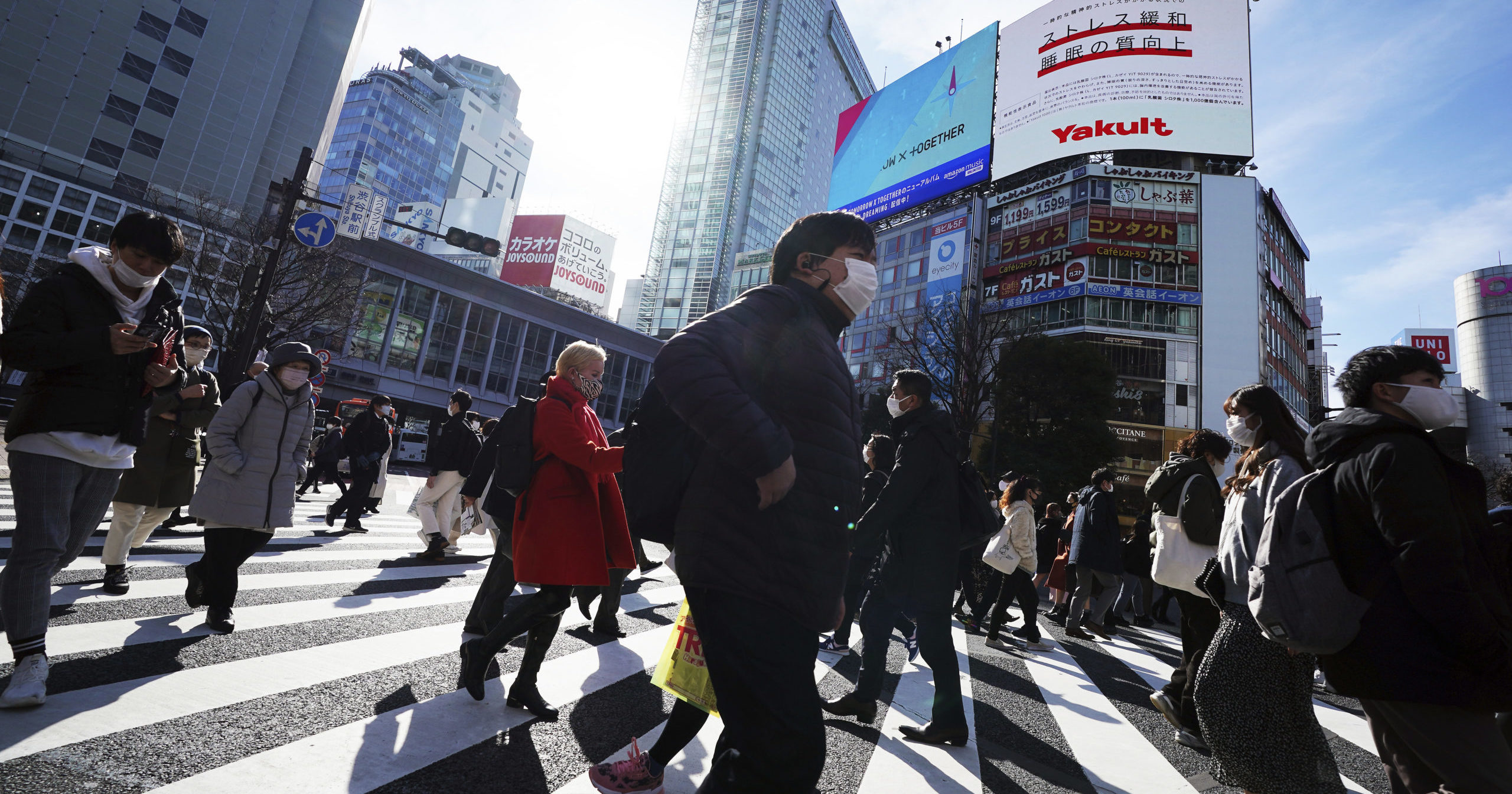 People walk along pedestrian crossings on Jan. 25, 2021, in Tokyo.