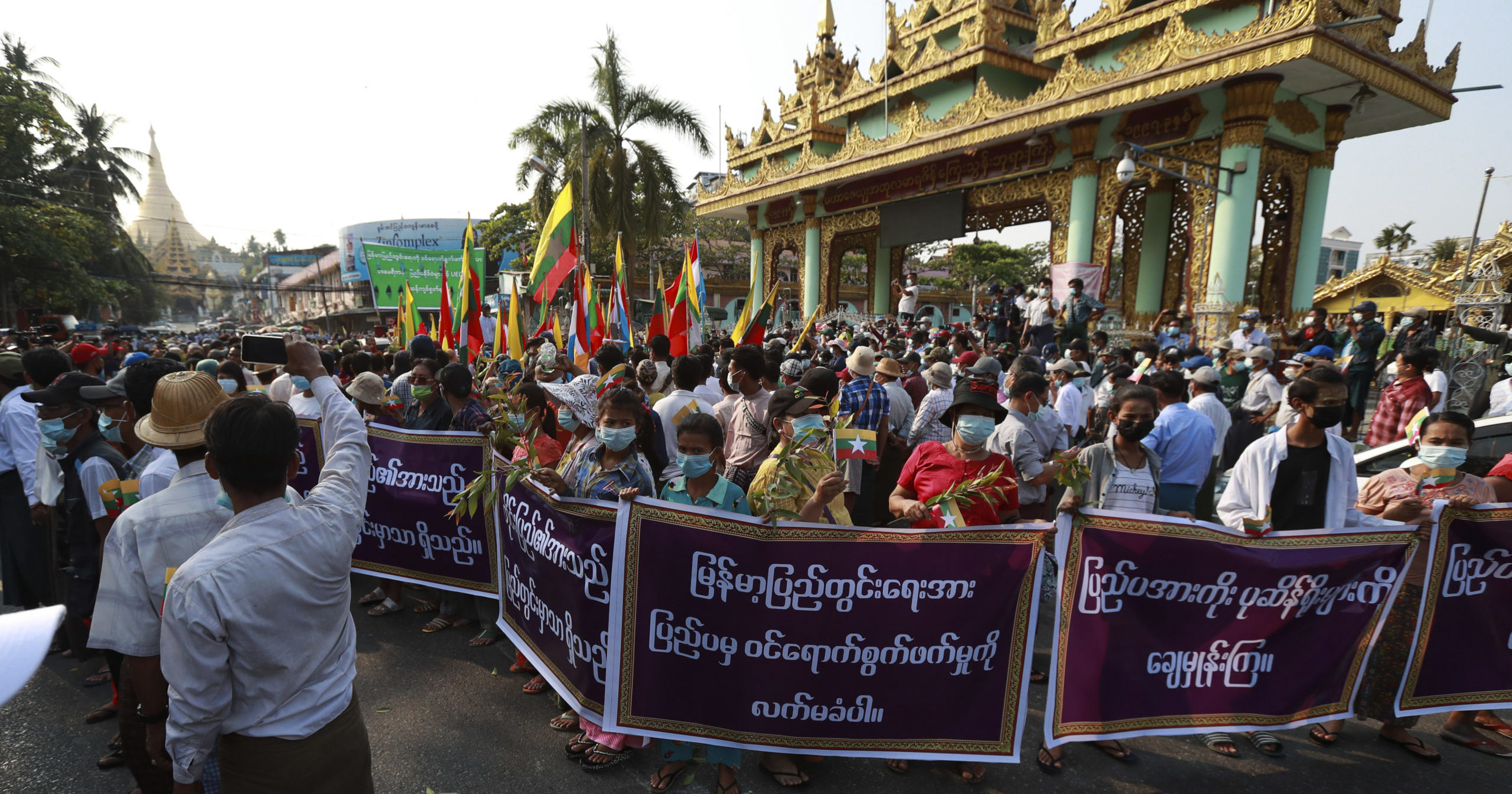 Supporters of the Myanmar military and the military-backed Union Solidarity and Development Party hold placards that read, "Do not accept interference by foreign countries. Wipe out those relying on external elements," as they protest election results during a rally near Shwedagon pagoda in Yangon on Saturday.