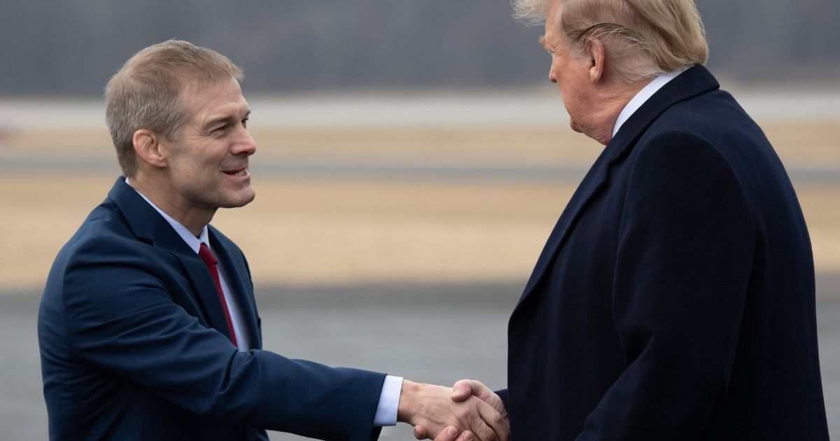 President Donald Trump shakes hands with Rep. Jim Jordan of Ohio as he disembarks from Air Force One upon arrival at Lima Allen County Airport in Lima, Ohio, on March 20, 2019.