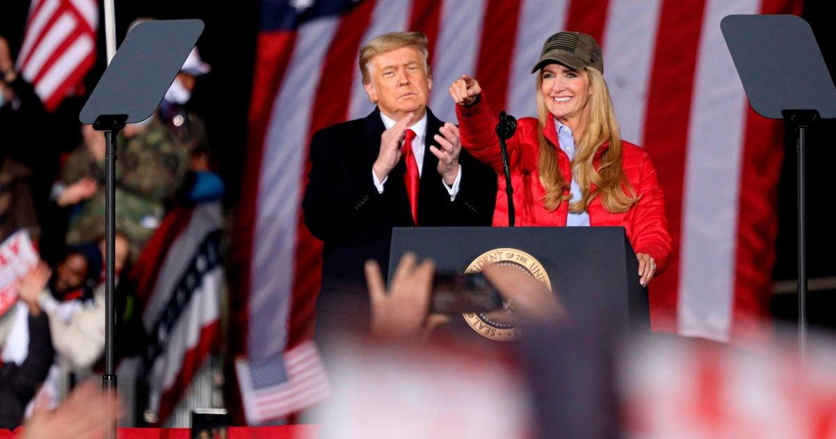 President Donald Trump applauds as Republican incumbent Sen. Kelly Loeffler speaks during a rally in Dalton, Georgia, on Jan. 4, 2021.