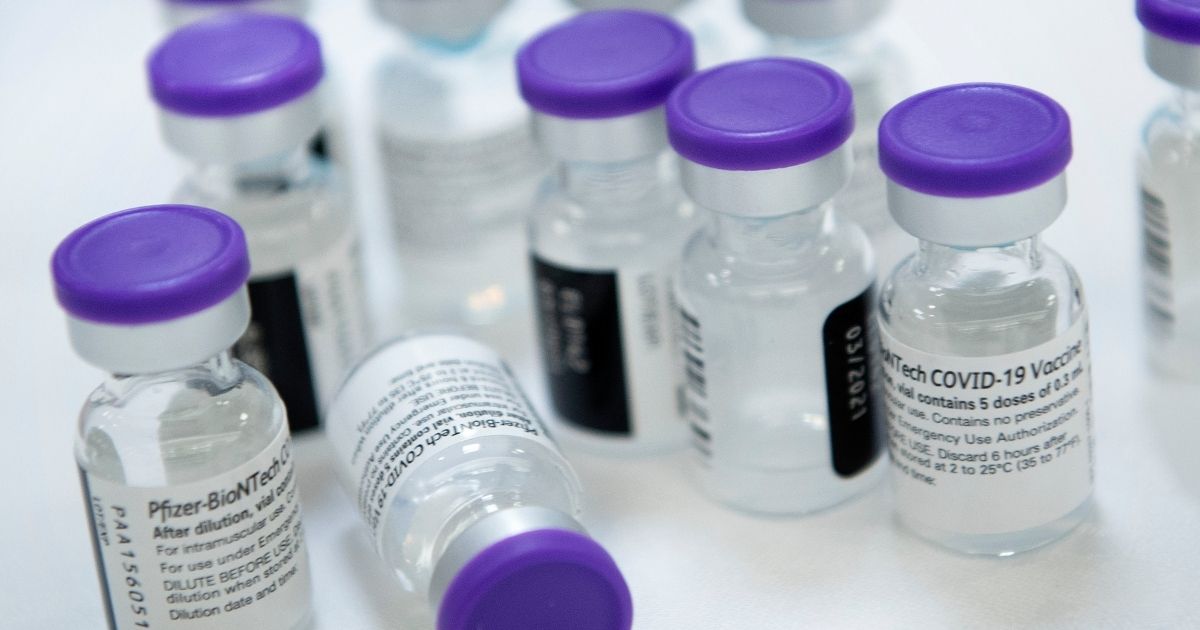 Vials of Pfizer's COVID-19 vaccine are prepared to administer to staff and residents at a senior living community in Falls Church, Virginia, on Dec. 30, 2020.