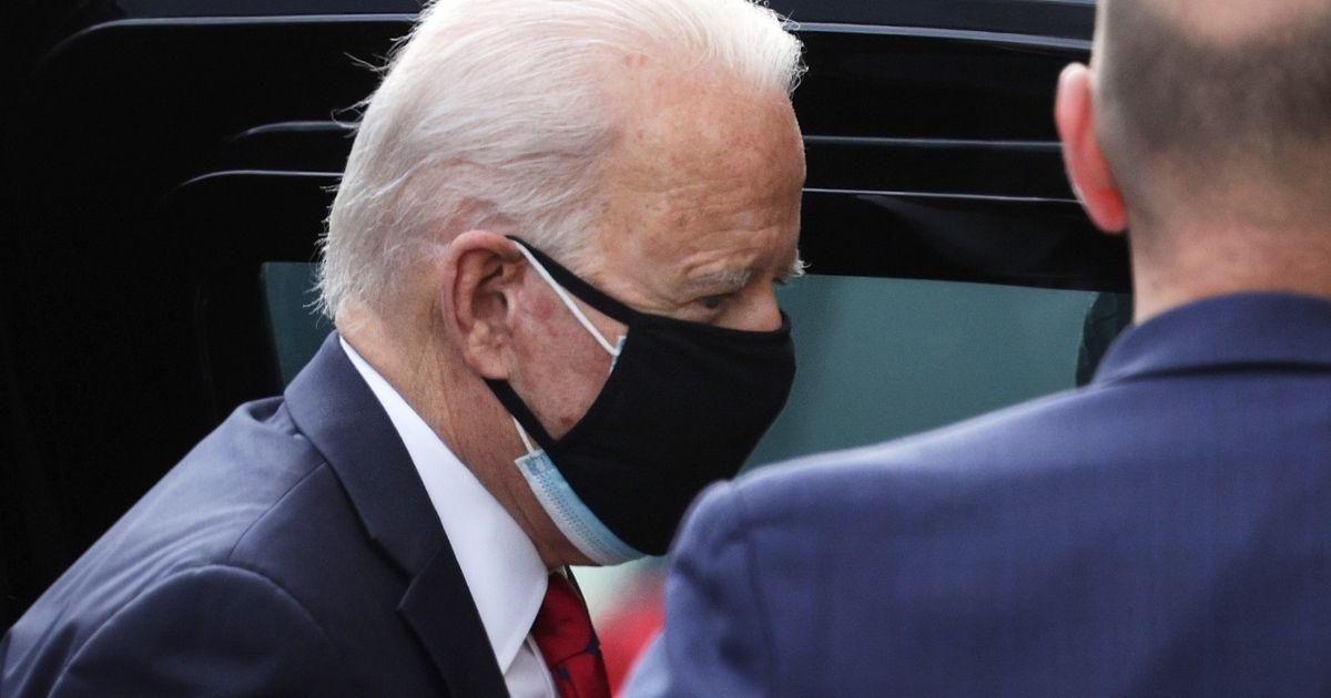 Then-President-elect Joe Biden wears two masks as he arrives at the Queen Theater in Wilmington, Delaware, on Jan. 15.