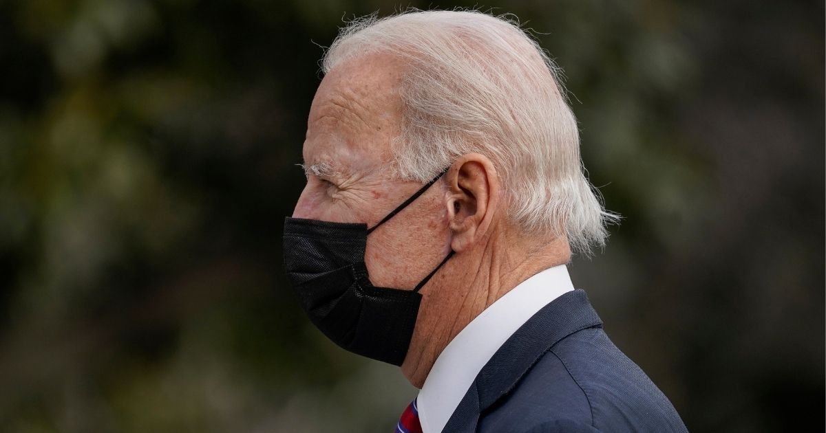 President Joe Biden wears a mask as he walks to the White House upon exiting Marine One on Jan. 29.