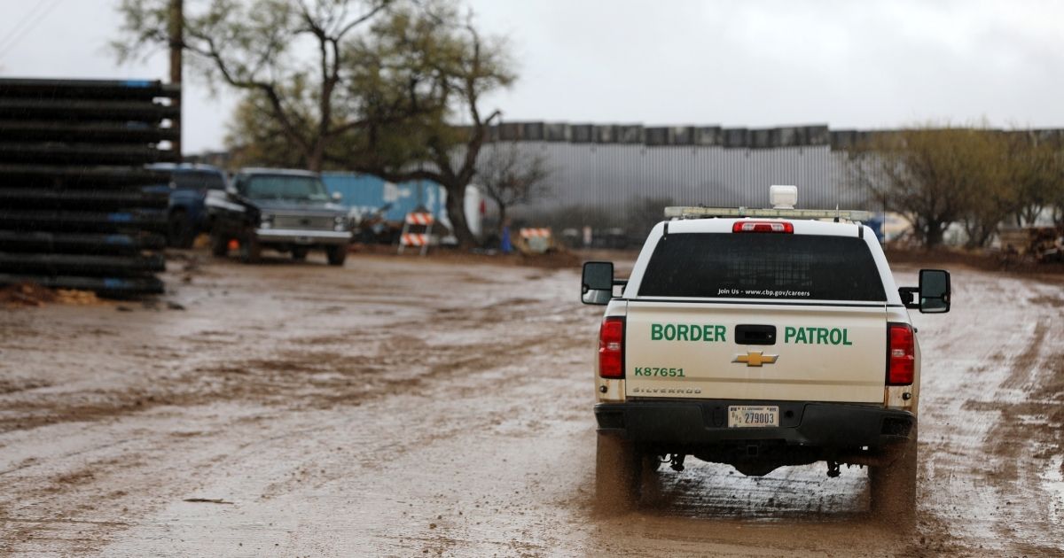 Workers move sections of the border wall on Jan. 21 in Sasabe, Arizona. President Joe Biden has issued executive actions pausing the construction within seven days of a border wall along the U.S.-Mexico border.