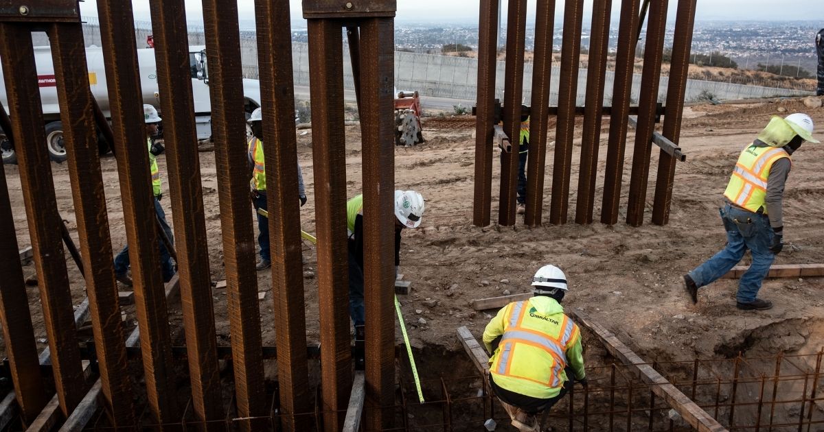A construction crew works on replacing the U.S.-Mexico border wall across from Tijuana, Mexico, on Jan. 9, 2019.