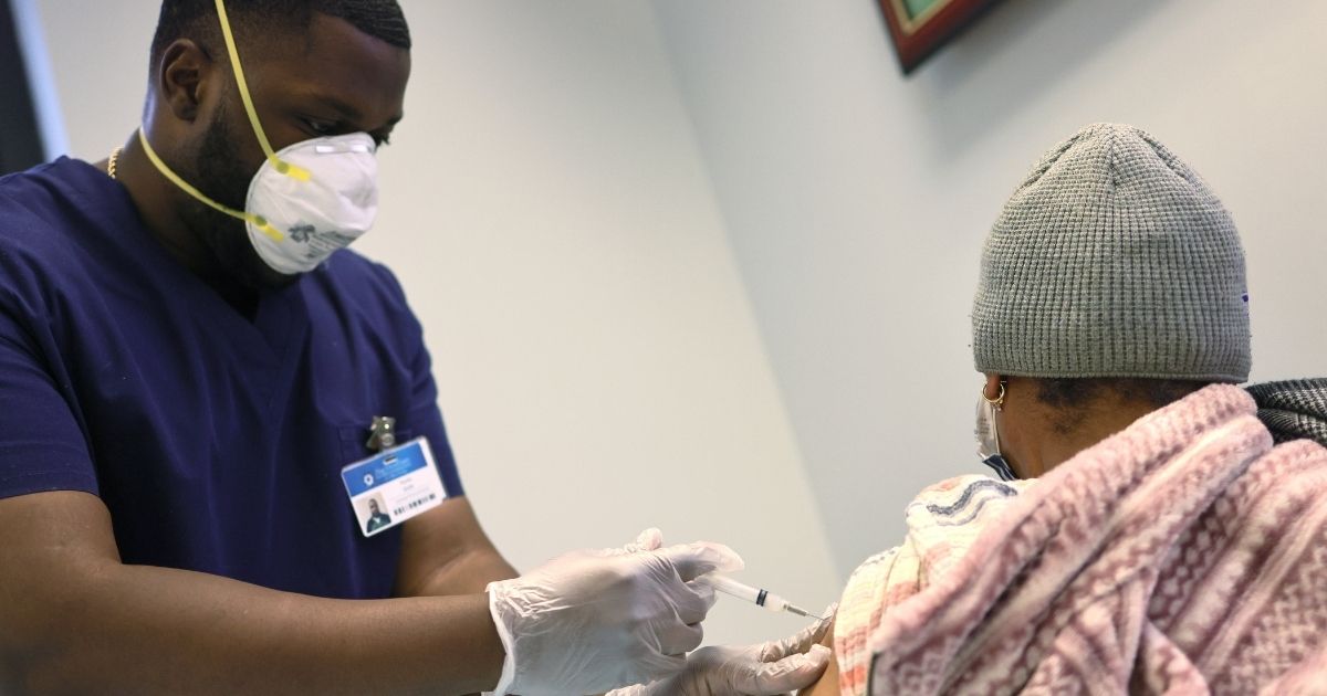 Kurtis Smith gives the Moderna coronavirus vaccine to a resident at Red Hook Neighborhood Senior Center in the Red Hood neighborhood of the Brooklyn borough on Feb. 22 in New York City.