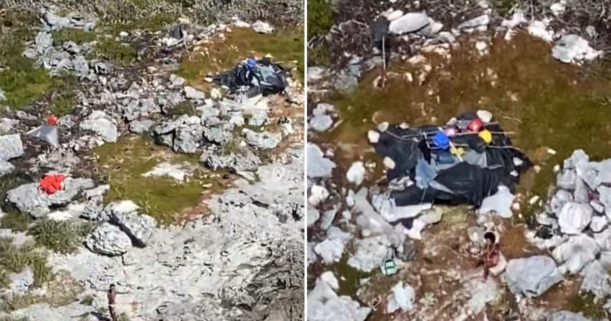 Three people are stranded with a makeshift shelter on Anguilla Cay, Bahamas, Feb. 8, 2021. A Coast Guard Air Station Clearwater MH-60 helicopter crew hoisted the two men and one woman and transferred them to Lower Keys Medical Center with no reported injuries.