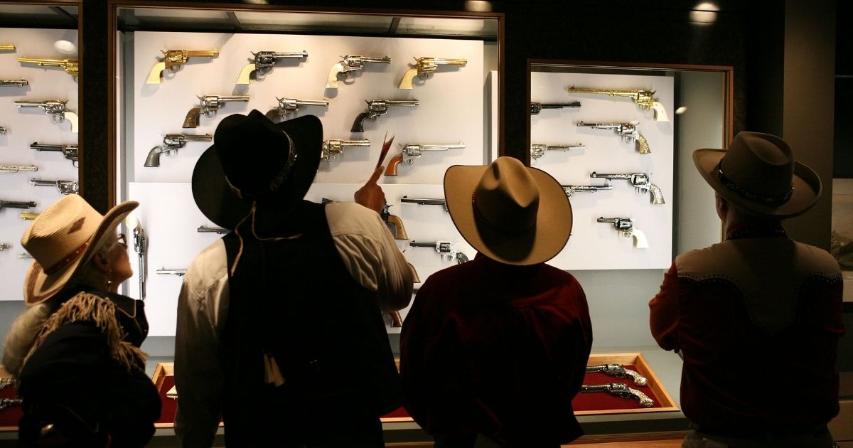 The crowd gathers in the newly opened exhibit "The Colt Revolver in the American West" during the Day of the Cowboy and Cowgirl at the Autry National Center on July 23, 2011, in Los Angeles.