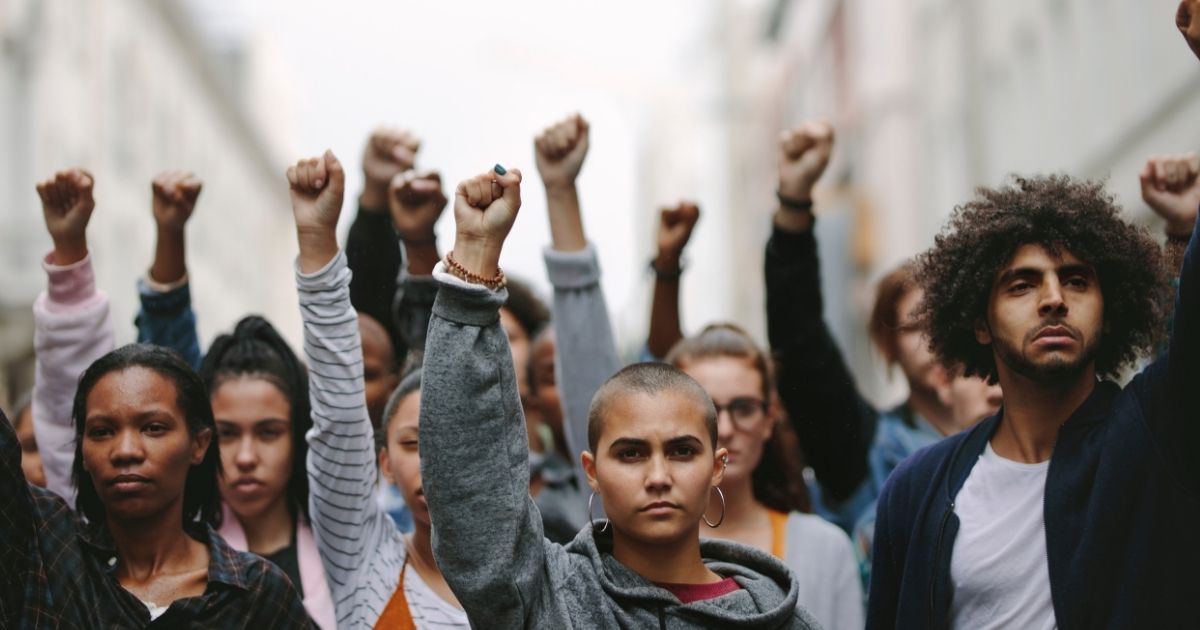 This stock photo portrays a group of Generation Z activists protesting. A new poll has found that 16 percent of Generation Z members identify as part of the LGBT community.